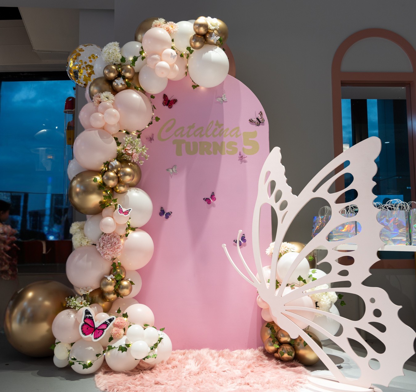 Butterfly birthday backdrop with soft pink, white and gold styling