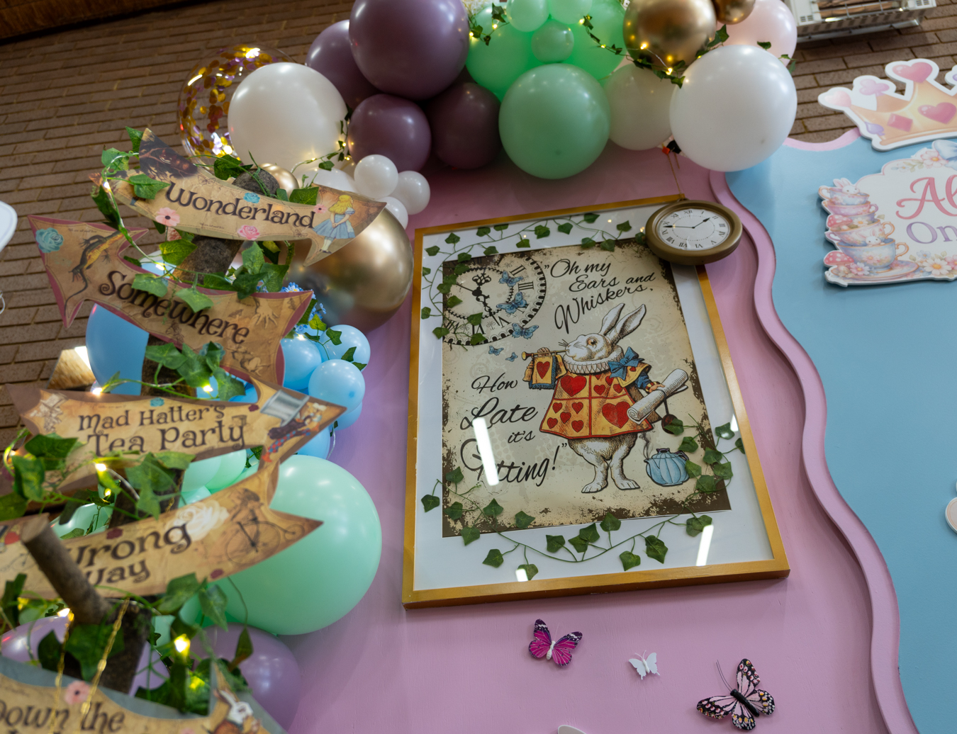 ONEderland styling details with pastel balloons, wavy backdrops and storybook signs